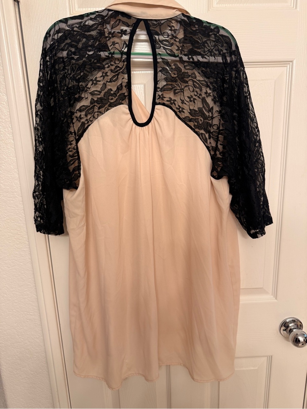 Very classic look. Light off white top , black lace sleeves Button front